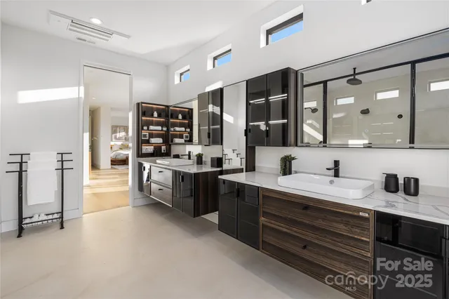 a large bathroom with a double vanity sink a mirror and a shower