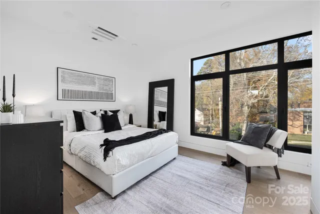 a spacious bedroom with a bed and a large window