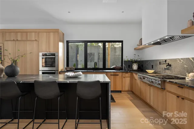 a kitchen with stainless steel appliances granite countertop a sink and a stove