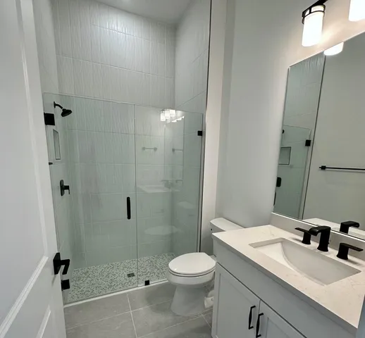 a bathroom with a sink toilet and shower