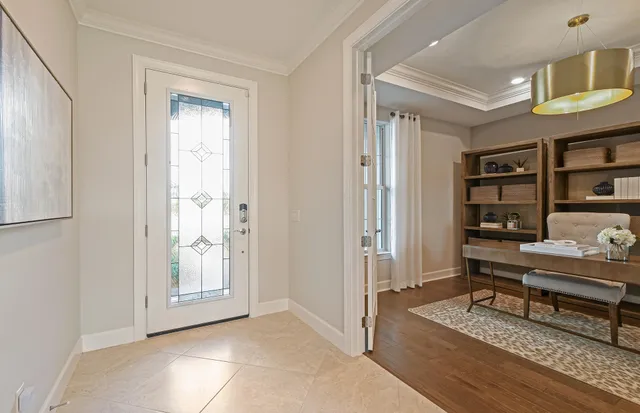 a view of a workspace with furniture and a window