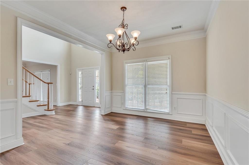 4115 Montvale Crossing Cumming, GA 30041 - Photo 11 of 38 a view of an empty room with wooden floor and a window