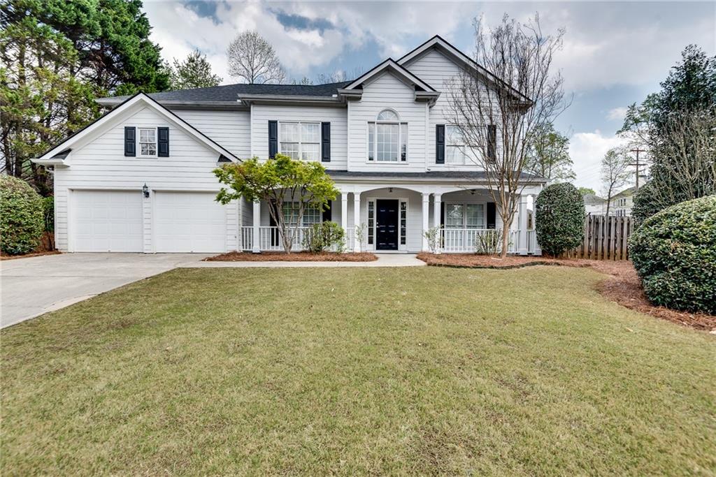 4115 Montvale Crossing Cumming, GA 30041 - Photo 2 of 38 a front view of a house with garden