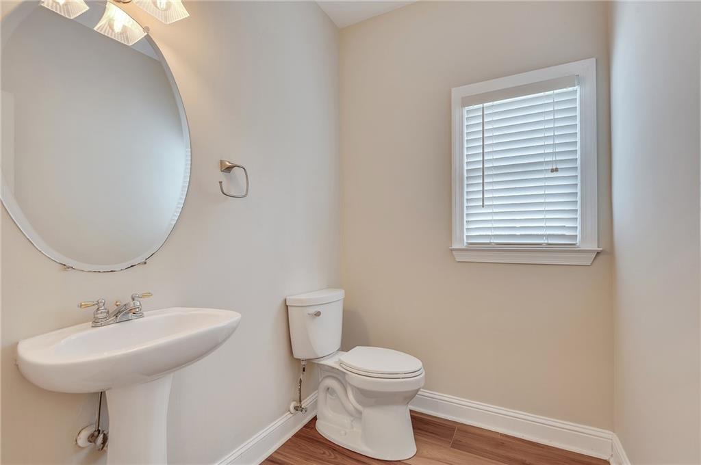 4115 Montvale Crossing Cumming, GA 30041 - Photo 21 of 38 a bathroom with a sink a mirror and a toilet