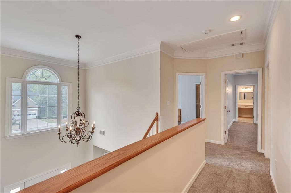 4115 Montvale Crossing Cumming, GA 30041 - Photo 23 of 38 a view of a hallway with entryway windows and a chandelier