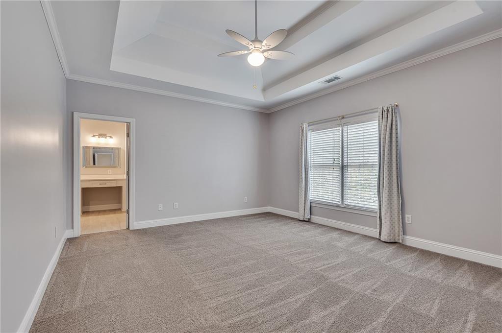 4115 Montvale Crossing Cumming, GA 30041 - Photo 24 of 38 an empty room with windows and ceiling fan