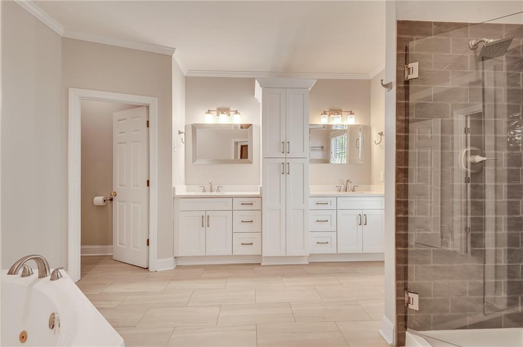 4115 Montvale Crossing Cumming, GA 30041 - Photo 26 of 38 a bathroom with a sink shower and a mirror