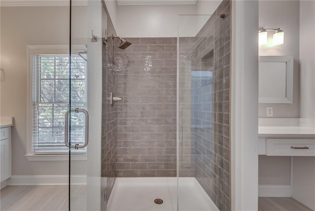4115 Montvale Crossing Cumming, GA 30041 - Photo 27 of 38 a bathroom with a shower and a bath tub