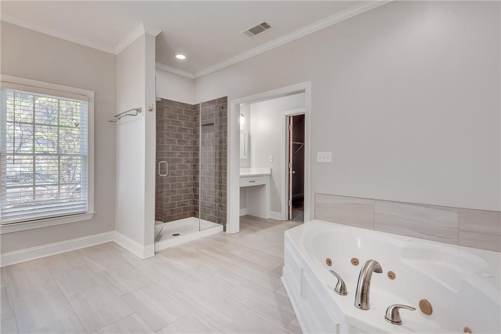 4115 Montvale Crossing Cumming, GA 30041 - Photo 28 of 38 a bathroom with a bathtub and a shower
