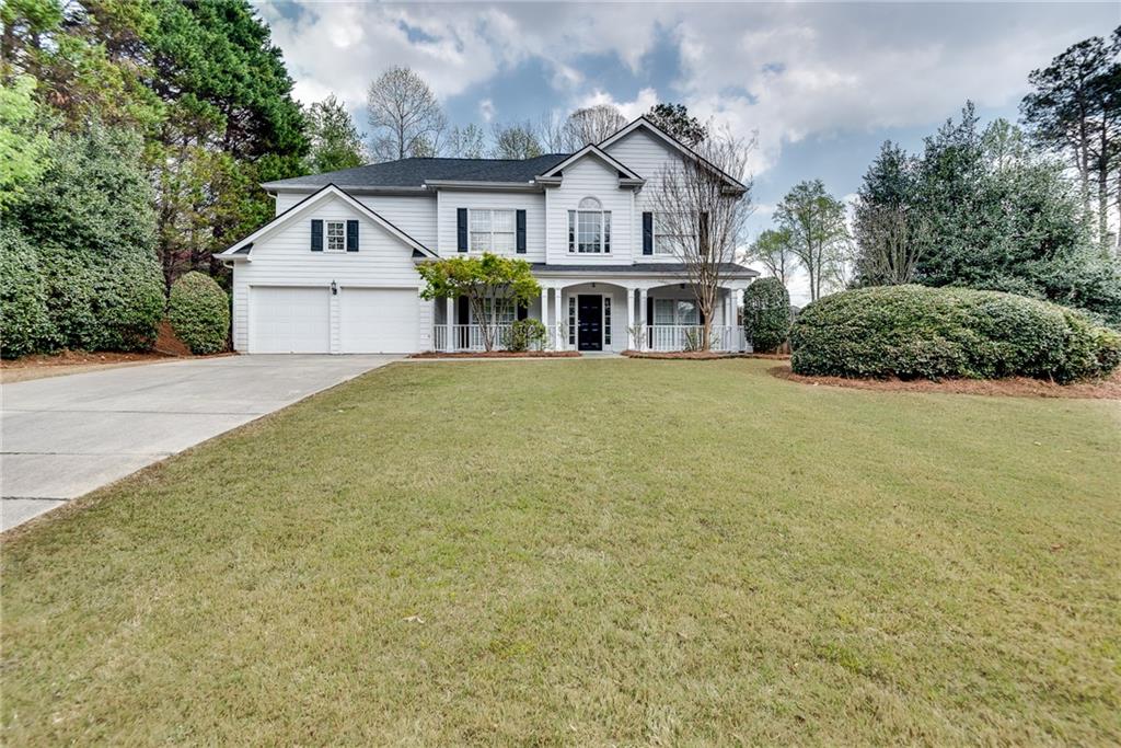 4115 Montvale Crossing Cumming, GA 30041 - Photo 3 of 38 a view of a big house with a big yard and large trees