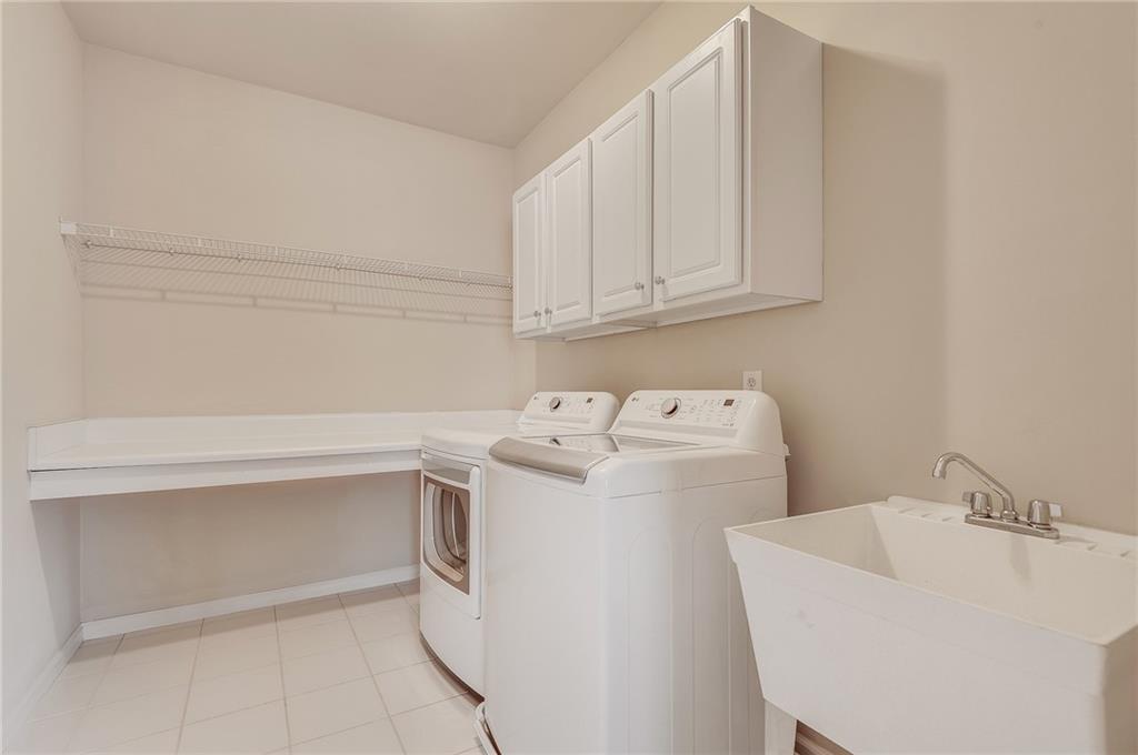4115 Montvale Crossing Cumming, GA 30041 - Photo 31 of 38 a utility room with dryer and washer