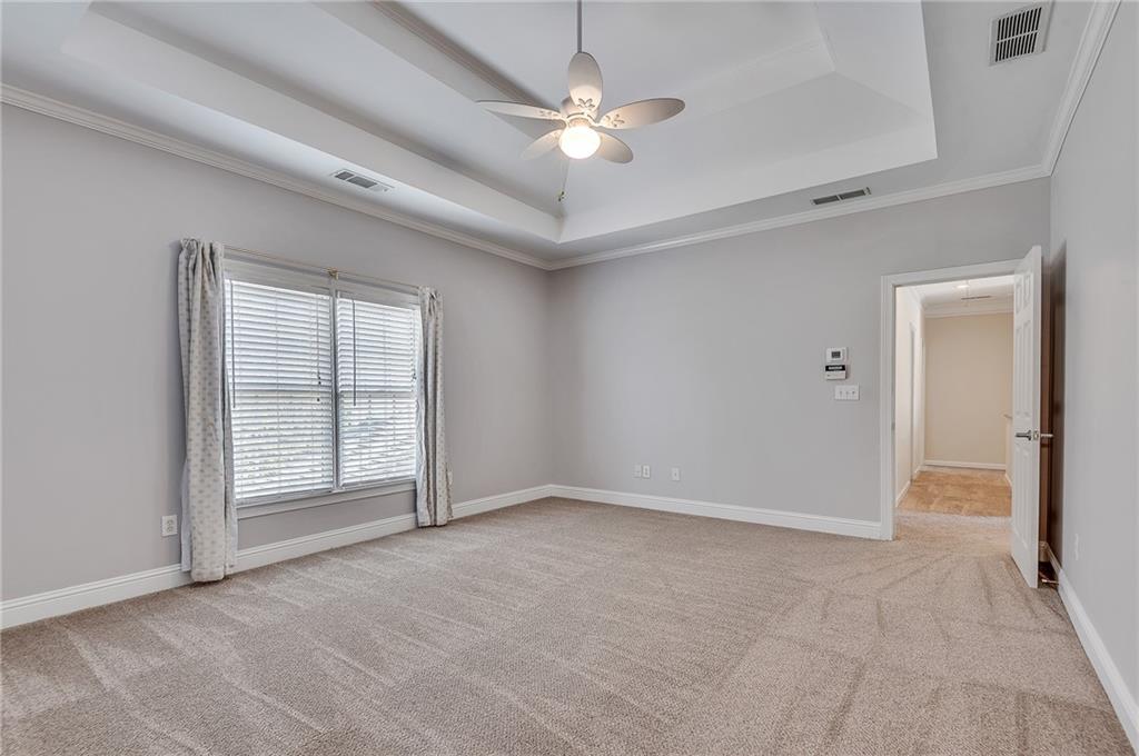 4115 Montvale Crossing Cumming, GA 30041 - Photo 33 of 38 an empty room with chandelier fan and windows