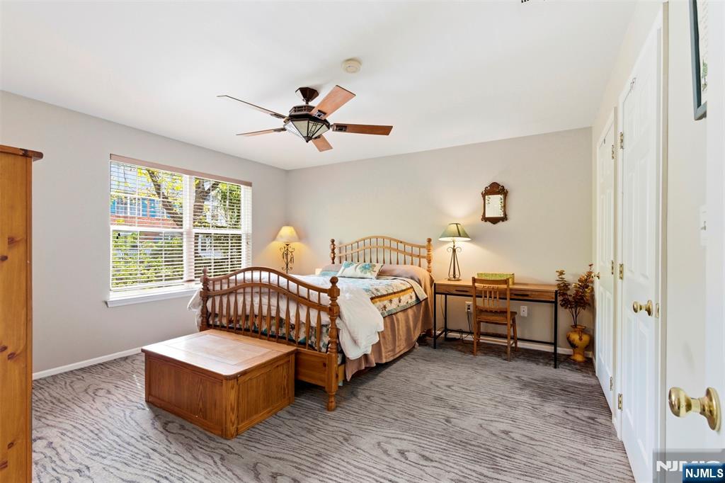 2063 Drake Court Mahwah, NJ 07430 - Photo 15 of 25 a bedroom with a bed and a chandelier