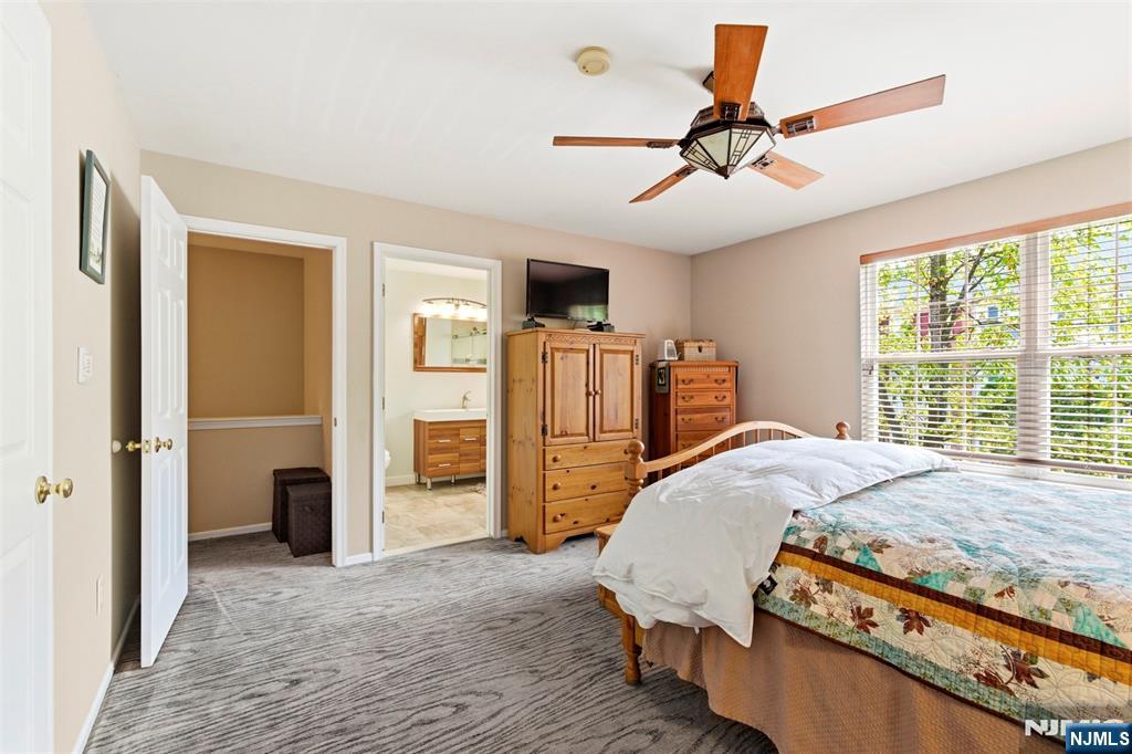 2063 Drake Court Mahwah, NJ 07430 - Photo 16 of 25 a bedroom with a bed and a chandelier