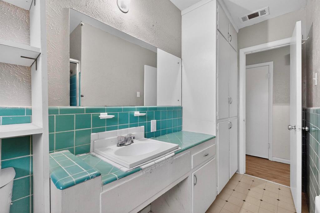 4508 Rutland Avenue Fort Worth, TX 76133 - Photo 22 of 36 a bathroom with a sink and a mirror