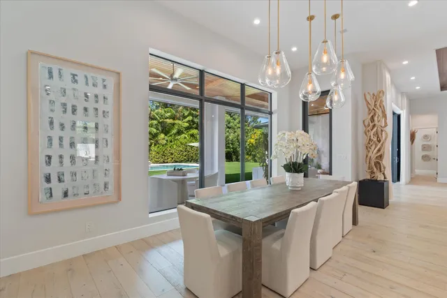 a view of a dining room with furniture a chandelier and wooden floor