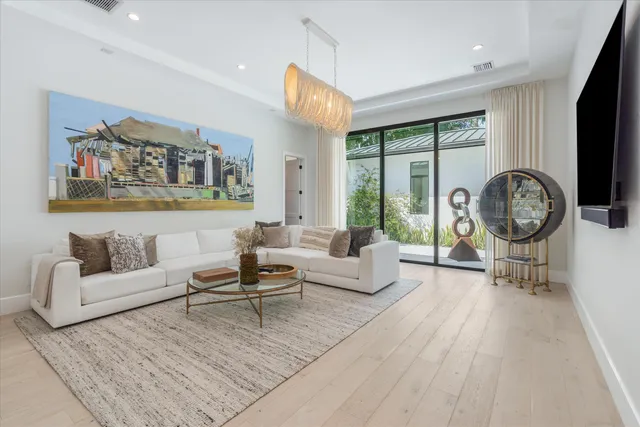 a living room with patio furniture and garden