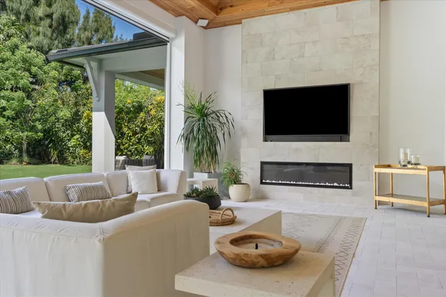 an aerial view of residential houses with outdoor space and trees