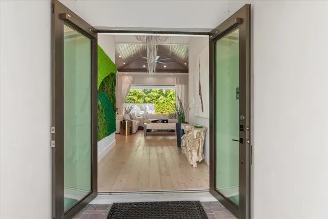 a kitchen with stainless steel appliances granite countertop white cabinets granite counter tops and a wooden floors