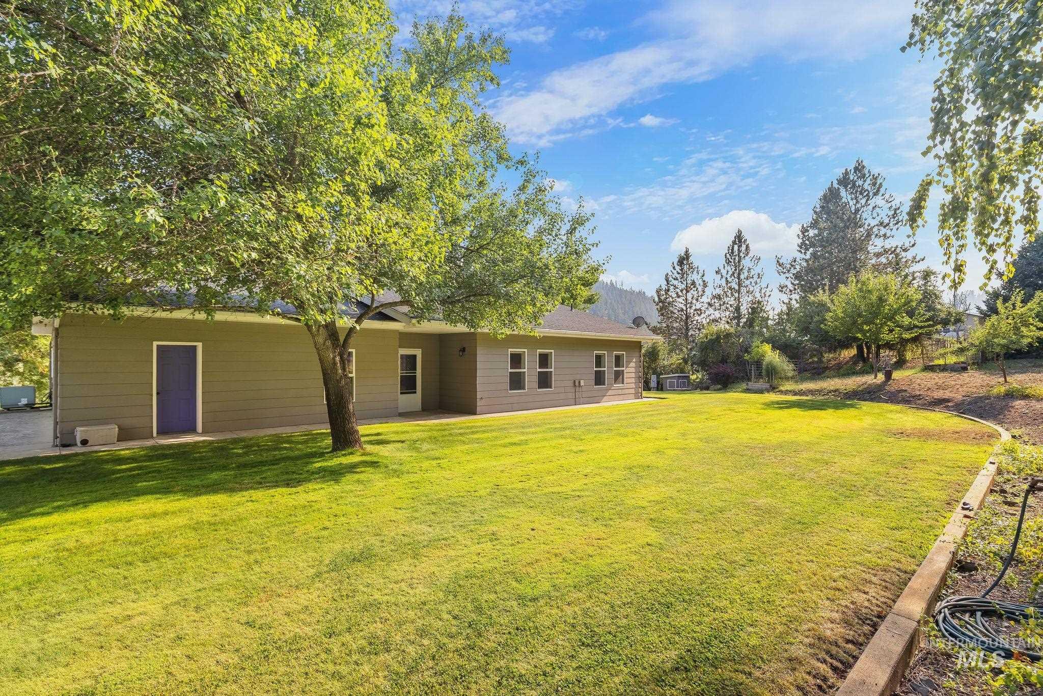 1091 Cedar Ridge Road Kendrick, ID 83537 - Photo 4 of 48 Expansive backyard featuring a manicured lawn, mature trees, and a terraced landscape