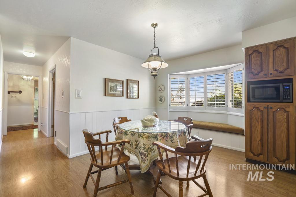 2018 Rancho Vista Drive Twin Falls, ID 83301 - Photo 17 of 50 Dining area featuring wood-finish flooring and white wainscoting