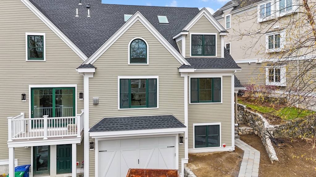 10 Deer Path Lane, Unit 10 Reading, MA 01867 - Photo 1 of 23 a view of a white house with large windows