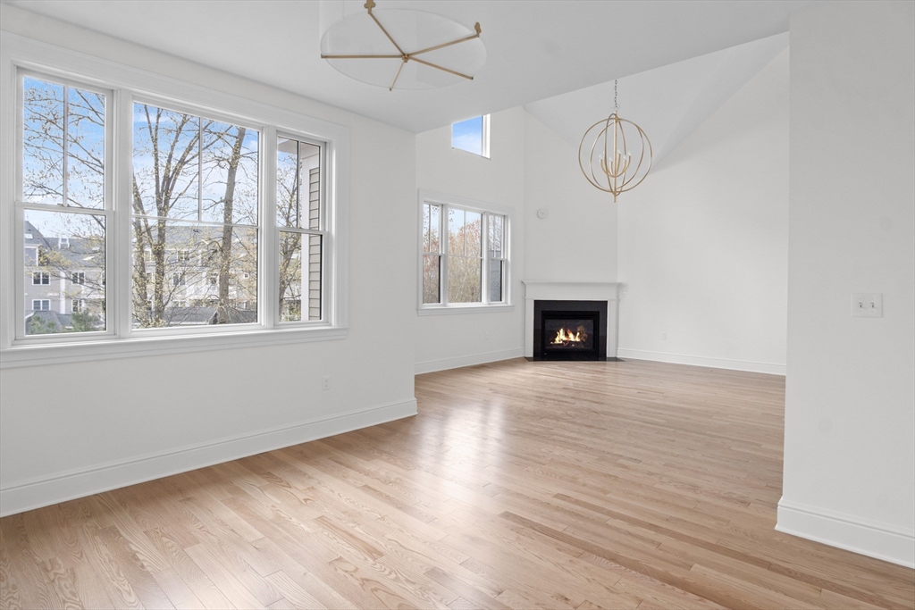 10 Deer Path Lane, Unit 10 Reading, MA 01867 - Photo 11 of 23 wooden floor in an empty room with a window