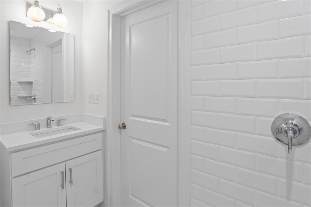 10 Deer Path Lane, Unit 10 Reading, MA 01867 - Photo 12 of 23 a bathroom with a sink and vanity