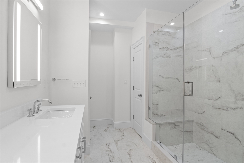 10 Deer Path Lane, Unit 10 Reading, MA 01867 - Photo 14 of 23 a bathroom with a sink a toilet and shower