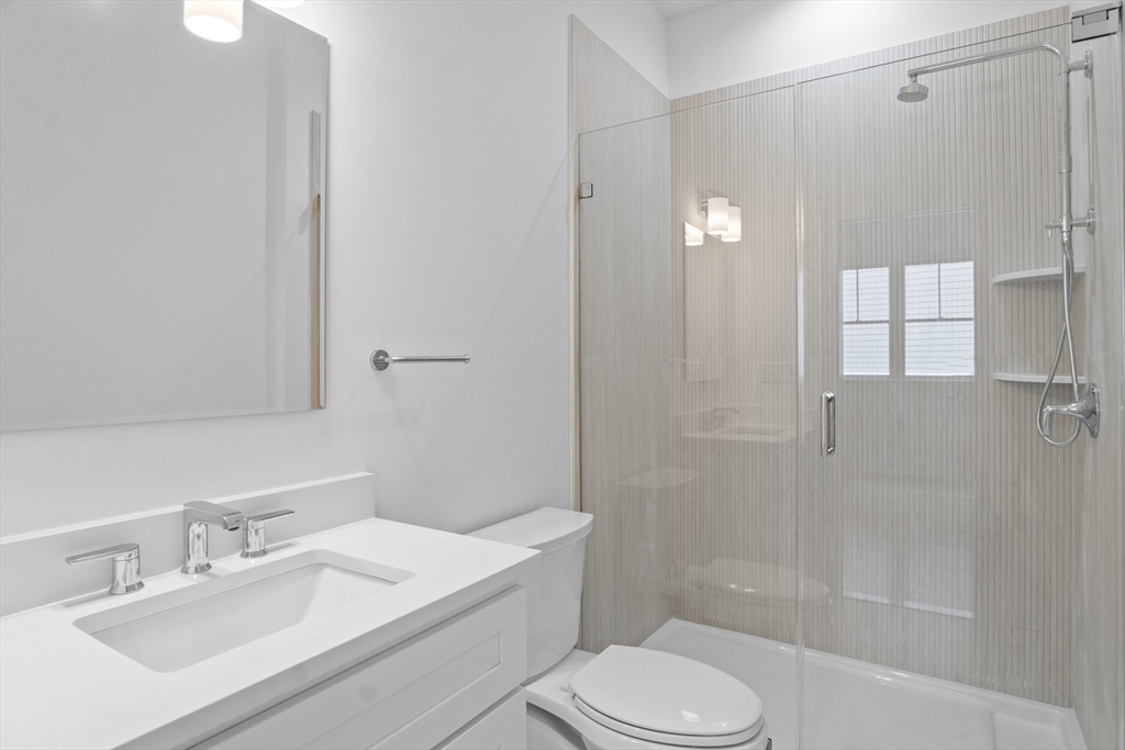 10 Deer Path Lane, Unit 10 Reading, MA 01867 - Photo 18 of 23 a bathroom with a sink toilet and shower