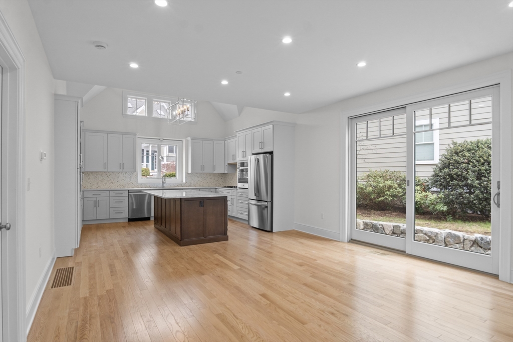 10 Deer Path Lane, Unit 10 Reading, MA 01867 - Photo 3 of 23 a kitchen with stainless steel appliances granite countertop a refrigerator and a stove top oven