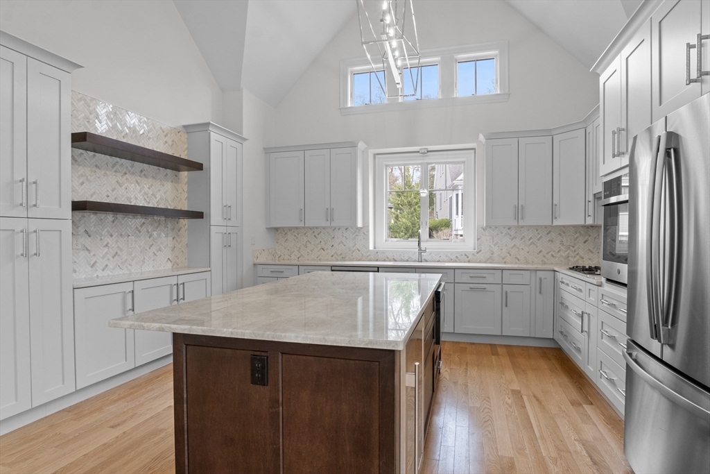 10 Deer Path Lane, Unit 10 Reading, MA 01867 - Photo 4 of 23 a kitchen with stainless steel appliances a refrigerator sink and cabinets