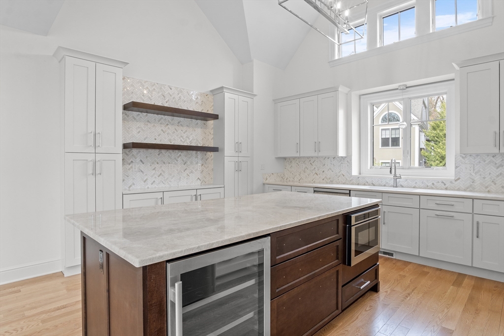 10 Deer Path Lane, Unit 10 Reading, MA 01867 - Photo 8 of 23 a kitchen that has a sink and a stove in it
