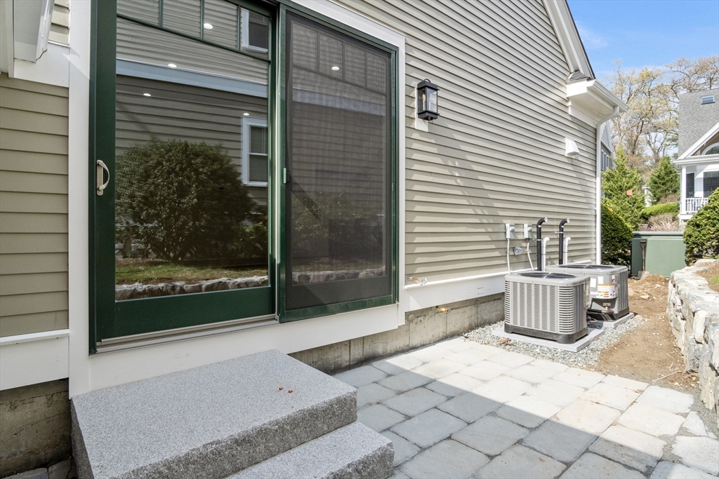 10 Deer Path Lane, Unit 10 Reading, MA 01867 - Photo 9 of 23 a backyard of a house with barbeque oven table and chairs