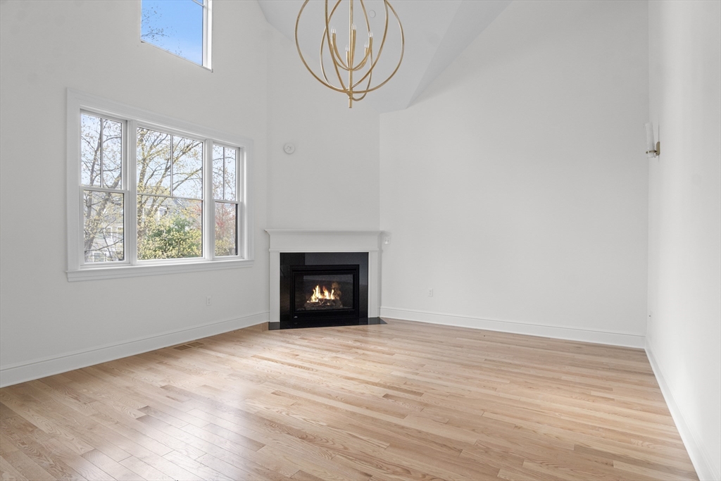 10 Deer Path Lane, Unit 10 Reading, MA 01867 - Photo 10 of 23 an empty room with wooden floor fan and windows