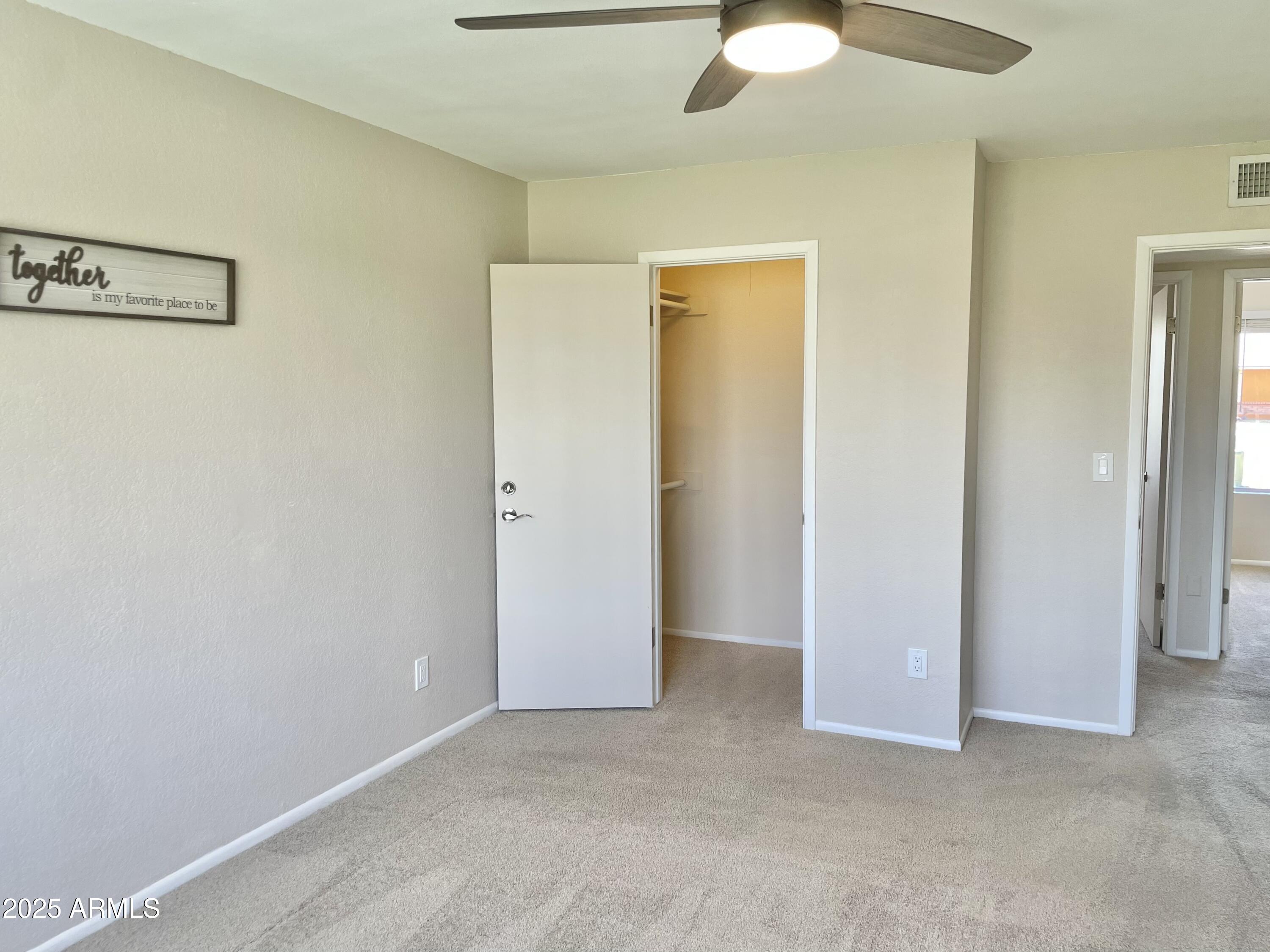 4038 West Windrose Drive Phoenix, AZ 85029 - Photo 28 of 43 an empty room with closet and a chandelier fan