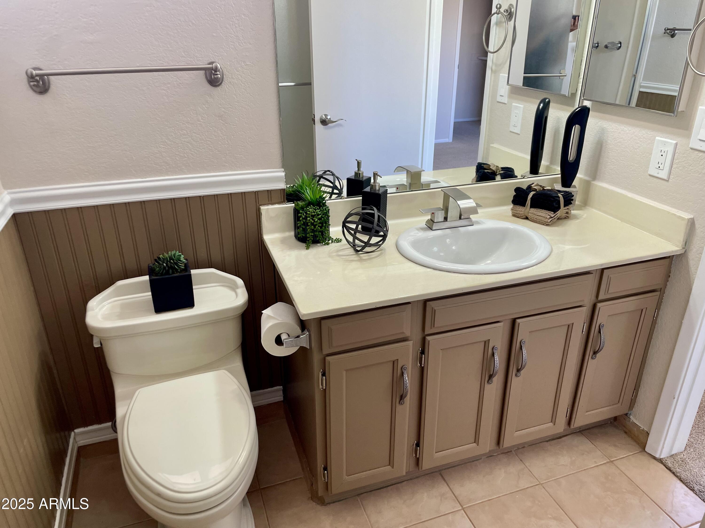 4038 West Windrose Drive Phoenix, AZ 85029 - Photo 31 of 43 a bathroom with a sink a toilet and a mirror