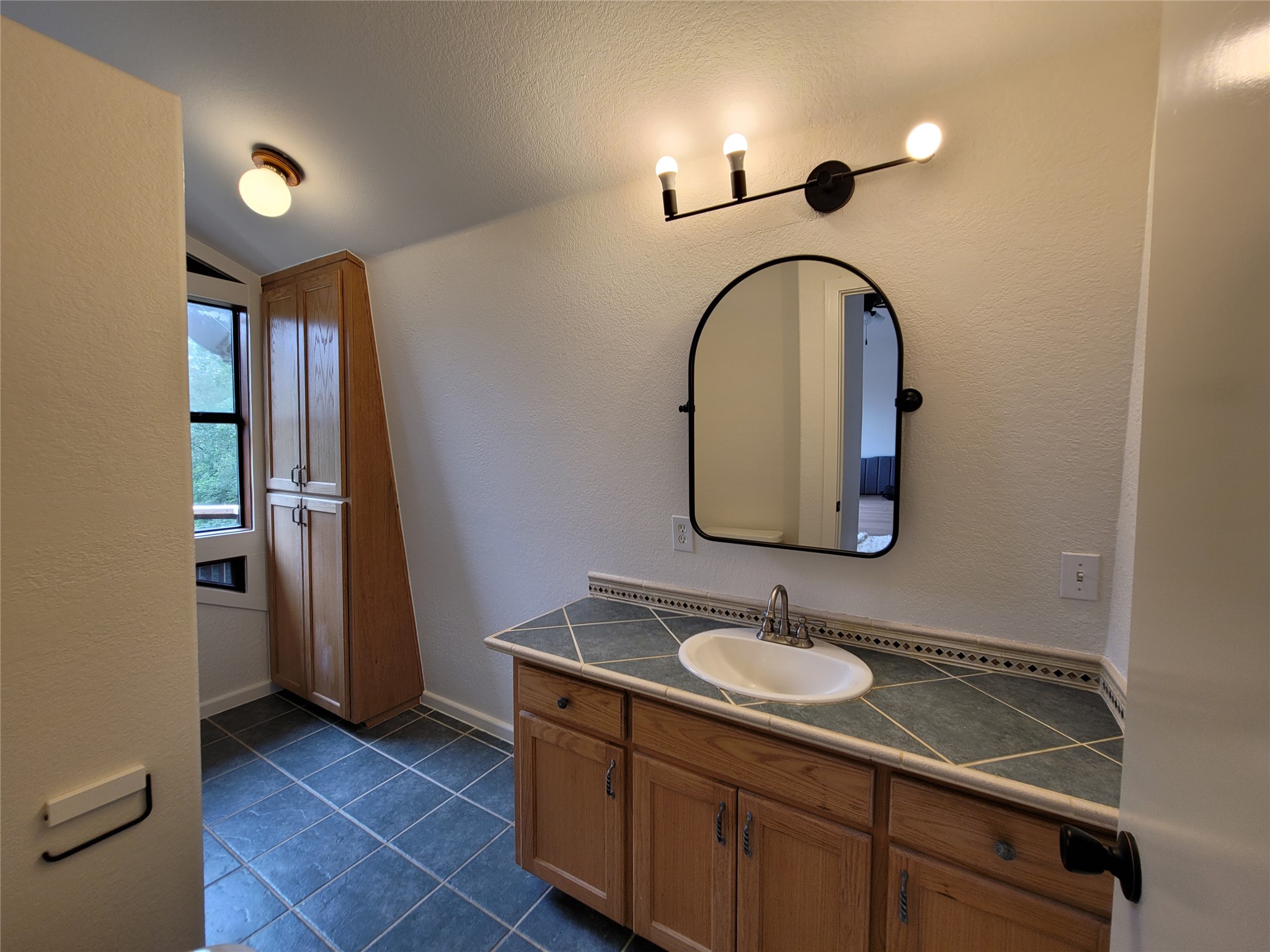 281 Earl Callahan Road, Unit A Cedar Creek, TX 78612 - Photo 23 of 39 a bathroom with a sink double vanity and a mirror