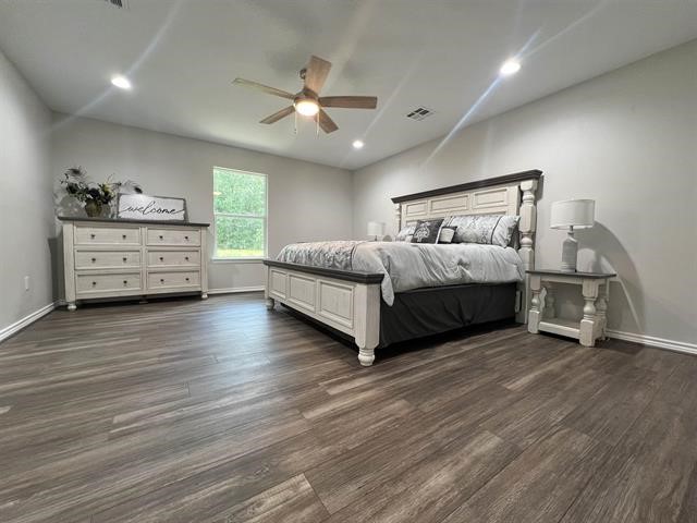 10516 Peck Road Lumberton, TX 77657 - Photo 12 of 27 a spacious bedroom with a bed and a dresser