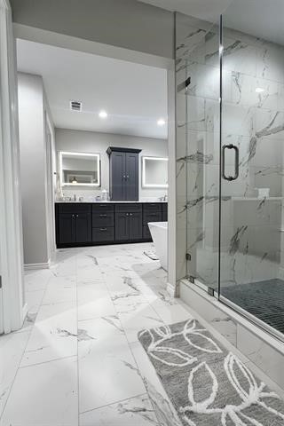 10516 Peck Road Lumberton, TX 77657 - Photo 15 of 27 a large bathroom with a large mirror vanity and shower