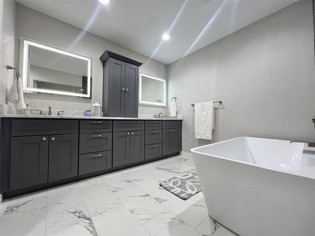 10516 Peck Road Lumberton, TX 77657 - Photo 17 of 27 a spacious bathroom with a tub sink and mirror