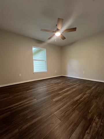 10516 Peck Road Lumberton, TX 77657 - Photo 20 of 27 an empty room with wooden floor and windows