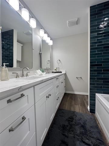 10516 Peck Road Lumberton, TX 77657 - Photo 23 of 27 a spacious bathroom with double vanity and a mirror
