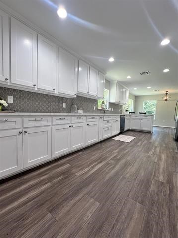 10516 Peck Road Lumberton, TX 77657 - Photo 6 of 27 a large kitchen with a lot of counter space and a wooden floor