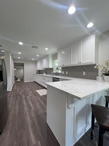 10516 Peck Road Lumberton, TX 77657 - Photo 9 of 27 a kitchen with stainless steel appliances granite countertop a sink a stove a refrigerator and a oven with wooden floor