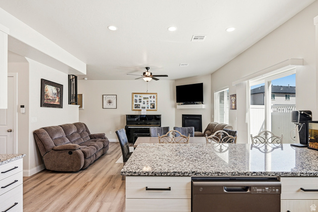 668 East Fiddlers Canyon Road, Unit 6 Cedar City, UT 84721 - Photo 9 of 36 Open-concept living area featuring wood-finish flooring, a contemporary fireplace, and a ceiling fan