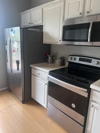 a kitchen with stainless steel appliances a stove a microwave and a refrigerator