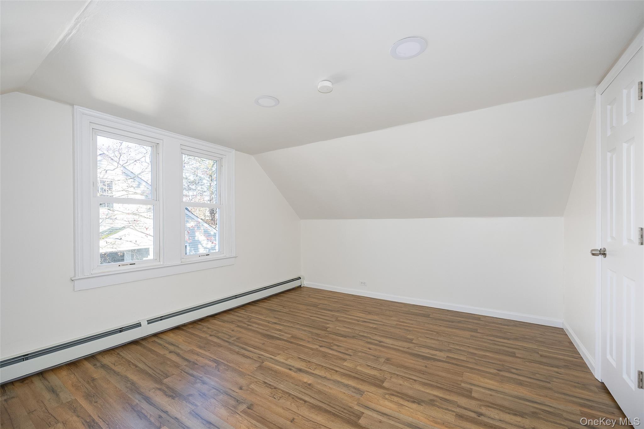 4 Walnut Street Poughkeepsie, NY 12601 - Photo 15 of 26 an empty room with wooden floor and windows