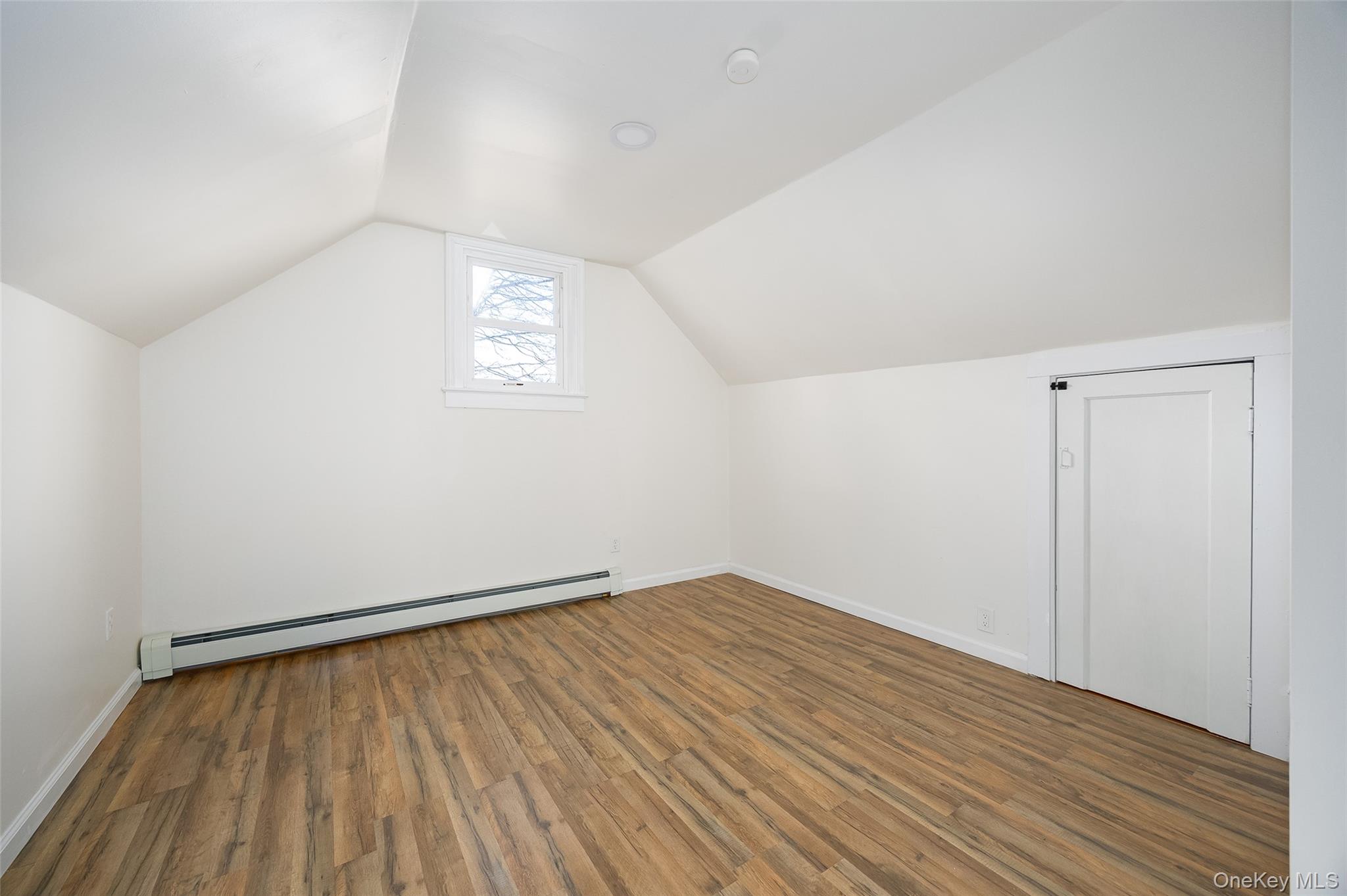 4 Walnut Street Poughkeepsie, NY 12601 - Photo 16 of 26 an empty room with wooden floor and windows