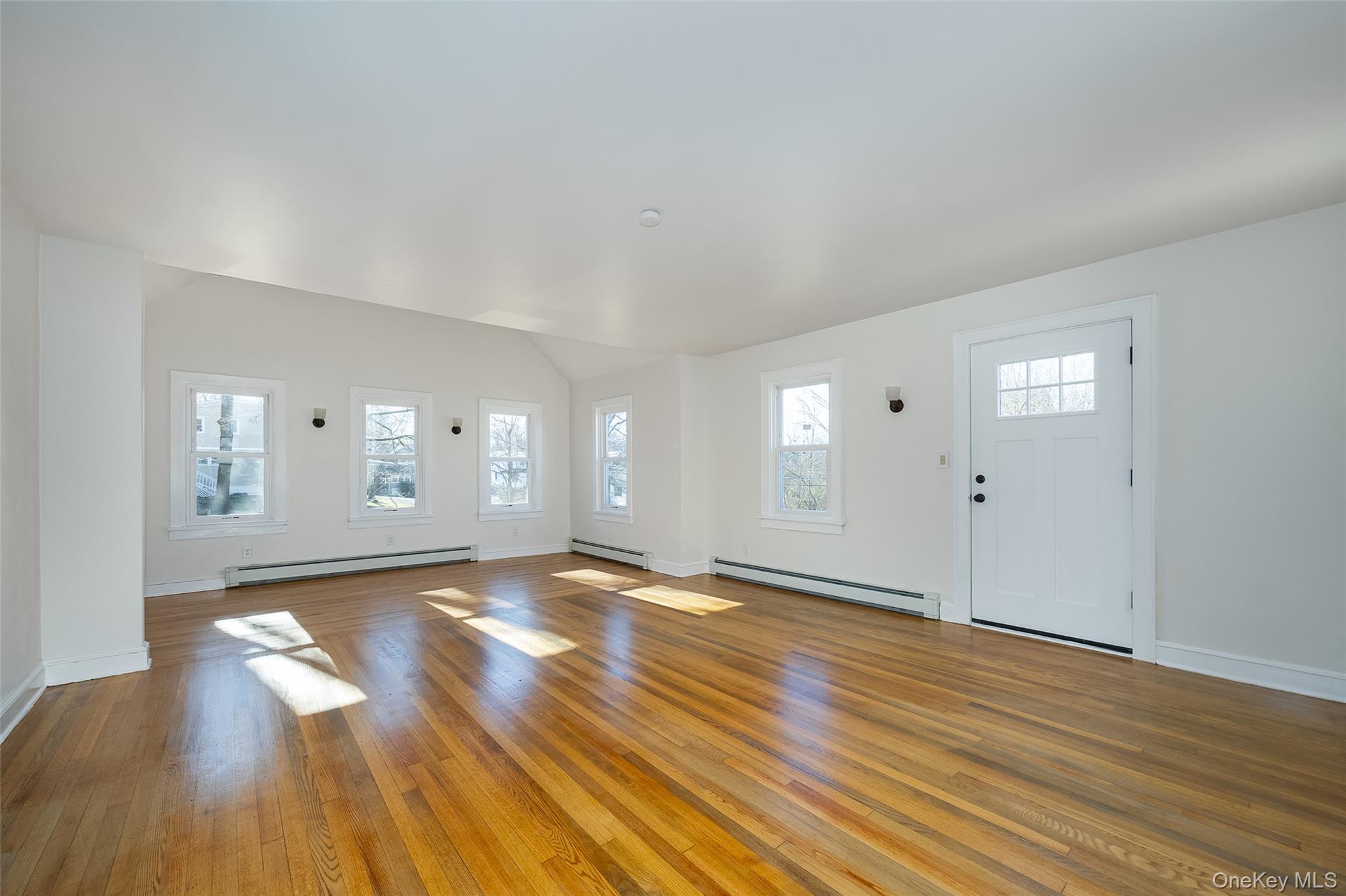 4 Walnut Street Poughkeepsie, NY 12601 - Photo 2 of 26 an empty room with wooden floor and windows